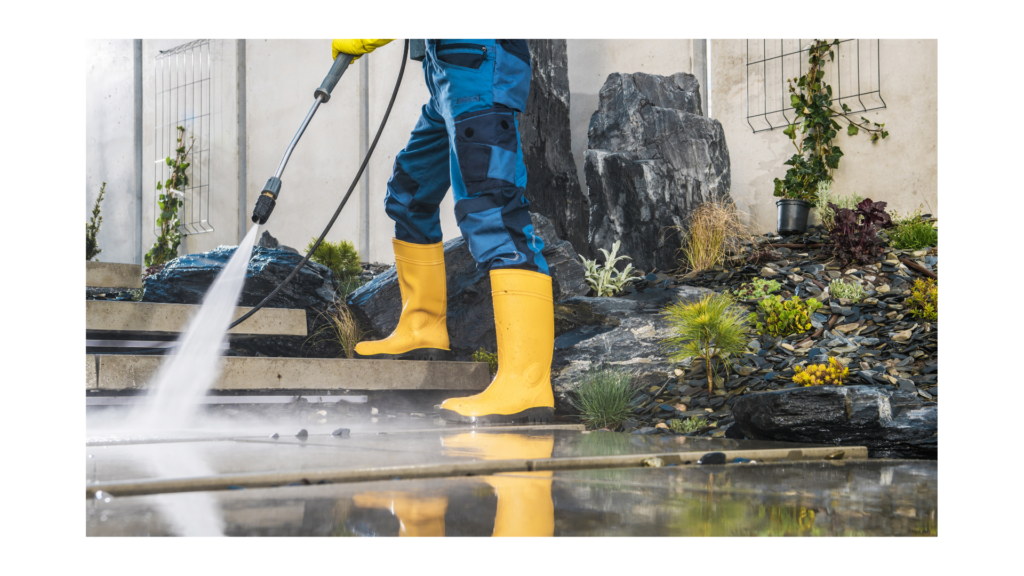 guy pressure washing ground